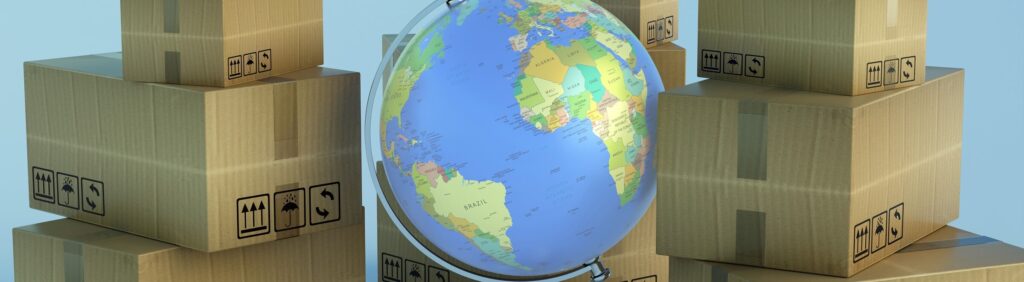 Stacks of cardboard shipping boxes surrounding a globe representing international trade and global shipping.